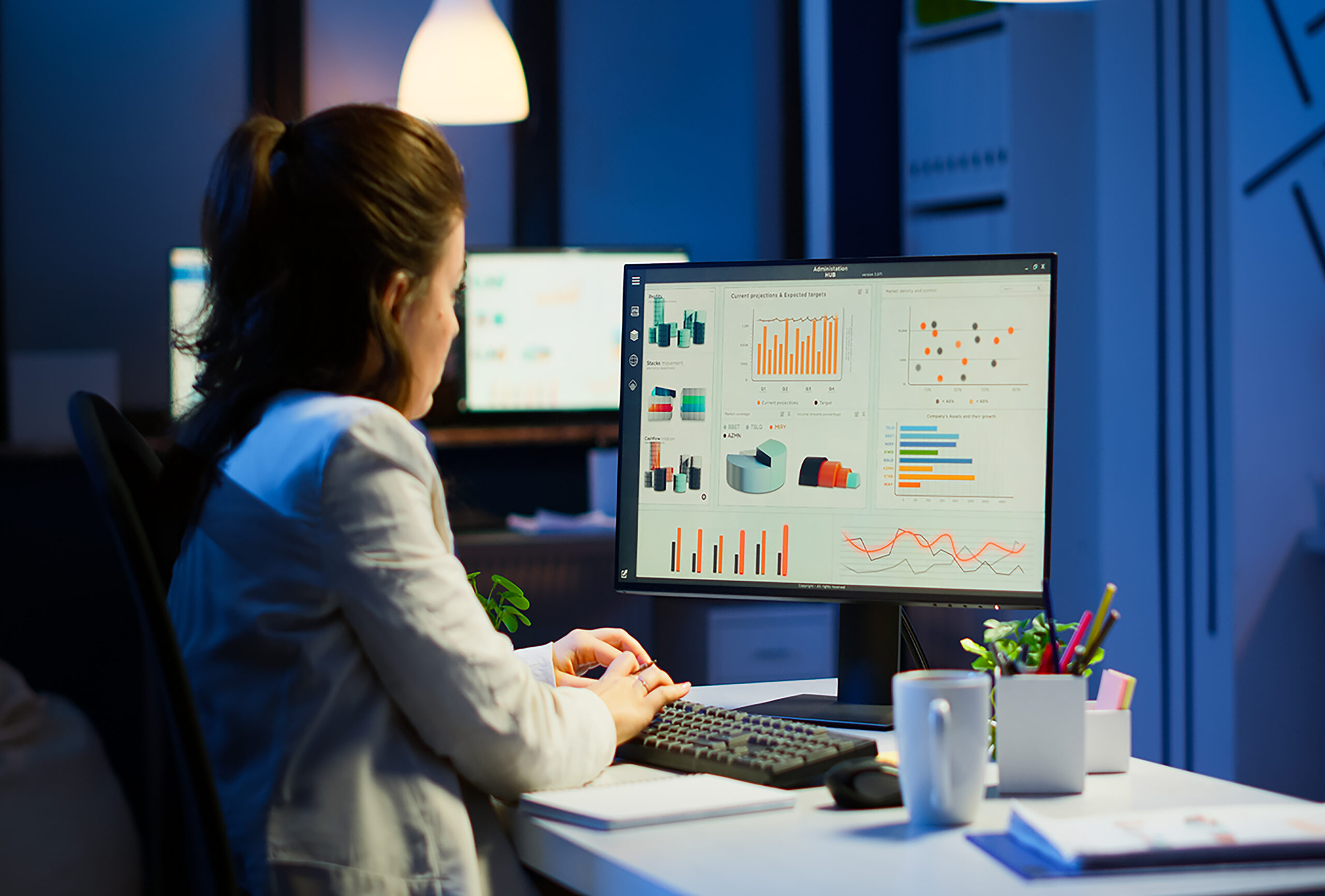 busy-woman-working-night-front-computer-taking-notes-writing-notebook-annual-reports-checking-financial-project-focused-employee-using-technology-network-wireless-doing-overtime-job